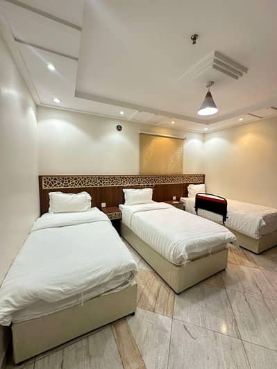 2 Bedroom Flat for Rent in Asharai, Makkah - Two rooms and a living room with a king bed and three single beds, one of them is room number 4