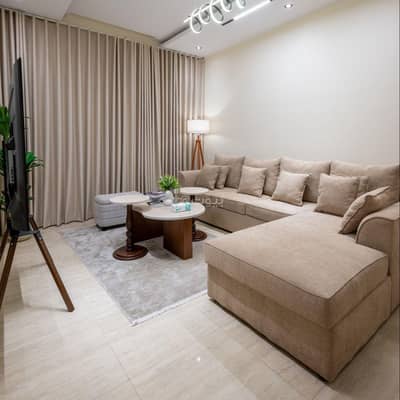 1 Bedroom Flat for Rent in Al Hamra, Al Khobar - A luxurious apartment with a living room and a bedroom