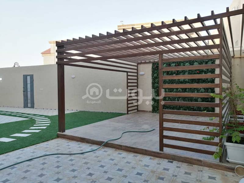 Villa with an internal staircase and 2 corner apartments for sale in Al Janadriyah, Riyadh
