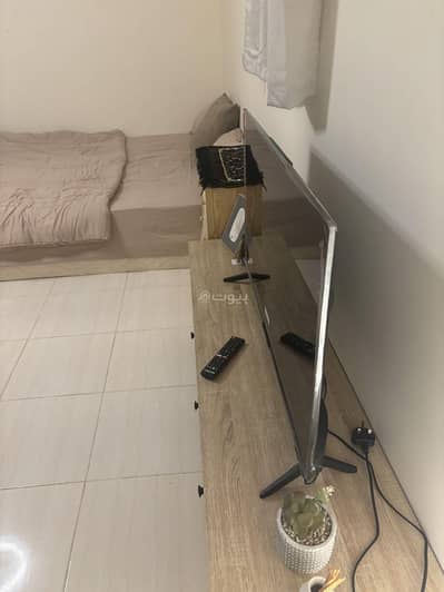 1 Bedroom Flat for Rent in Buraydah Al Qassim Region - A studio room and bathroom with a coffee corner for single families